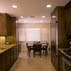 maple-cabinetry-stained-wenge-giallo-ornamental-granite-and-travertine-backsplash