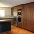 walnut-cabinetry-absolute-granite-travertine-tile-backsplash